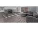 Bright living room featuring a modern fireplace, comfortable seating, and sleek wood flooring, perfect for relaxation at 6459 E Sugarloaf St, Mesa, AZ 85215