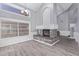 Bright and airy living room featuring a fireplace, a large window, and stylish wood floors for a modern feel at 6459 E Sugarloaf St, Mesa, AZ 85215