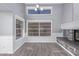 Bright living room featuring lots of natural light, gray plank flooring, and a cozy fireplace at 6459 E Sugarloaf St, Mesa, AZ 85215