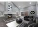 Spacious living room with a cozy fireplace, vaulted ceilings, and large windows providing ample natural light at 6459 E Sugarloaf St, Mesa, AZ 85215