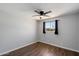 Bedroom with wood floors, a ceiling fan, and a window with curtains at 6743 S Jentilly Ln, Tempe, AZ 85283