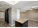 Kitchen with Granite Island, neutral walls, and wood-look tile flooring at 6743 S Jentilly Ln, Tempe, AZ 85283