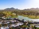 A high aerial view of this home in a well maintained community; lake and mountains nearby at 7710 N Via De Fonda St, Scottsdale, AZ 85258