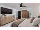 Bedroom featuring a dresser, television, ceiling fan, and interior barn door at 7710 N Via De Fonda St, Scottsdale, AZ 85258