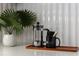 Close-up of a kitchen counter showcasing modern decor and a stylish French press at 7710 N Via De Fonda St, Scottsdale, AZ 85258