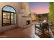 Exterior view showcasing a beautifully landscaped backyard with a fireplace and comfortable seating at 7710 N Via De Fonda St, Scottsdale, AZ 85258