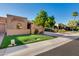 Well-maintained single-story home with a lush lawn and desert landscaping at 7710 N Via De Fonda St, Scottsdale, AZ 85258