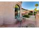 Charming outdoor seating area by an arched window and tiled roof detail at 7710 N Via De Fonda St, Scottsdale, AZ 85258