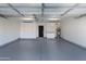 Clean and spacious garage with an epoxied floor, storage cabinets, and a water heater at 7710 N Via De Fonda St, Scottsdale, AZ 85258