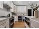 Bright kitchen featuring stainless steel appliances, white cabinets, and an island sink at 7710 N Via De Fonda St, Scottsdale, AZ 85258