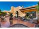 Beautiful outdoor patio featuring brick flooring, comfortable seating, lush greenery, and mature plants for a serene retreat at 7710 N Via De Fonda St, Scottsdale, AZ 85258
