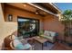 Relaxing covered patio featuring comfortable seating, a ceiling fan, and a sliding glass door for seamless indoor-outdoor living at 7710 N Via De Fonda St, Scottsdale, AZ 85258