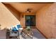Inviting outdoor patio with comfortable seating, ceiling fan, and seamless indoor-outdoor flow through the sliding glass door at 7710 N Via De Fonda St, Scottsdale, AZ 85258