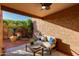 Relaxing patio featuring comfortable furniture, a ceiling fan, and a view of the lush greenery, perfect for outdoor enjoyment at 7710 N Via De Fonda St, Scottsdale, AZ 85258