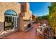 Exterior patio featuring brick accents, mature trees, and comfortable outdoor seating, perfect for enjoying the natural surroundings at 7710 N Via De Fonda St, Scottsdale, AZ 85258