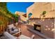 Charming outdoor patio with a cozy fireplace, brick flooring, and comfortable seating for enjoying relaxing moments outdoors at 7710 N Via De Fonda St, Scottsdale, AZ 85258