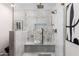 Luxurious shower featuring marble tile, a built-in bench, and a rainfall shower head at 7710 N Via De Fonda St, Scottsdale, AZ 85258