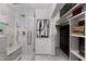 Modern shower with a marble tile, a built in bench, and glass enclosure at 7710 N Via De Fonda St, Scottsdale, AZ 85258