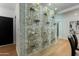 Unique wine display featuring gold geometric shelving, stone wall, and modern design at 7710 N Via De Fonda St, Scottsdale, AZ 85258
