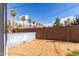 Spacious dirt back yard enclosed by a block wall and featuring mature palm trees at 813 N Gilbert Ave, Casa Grande, AZ 85122