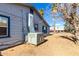 Side view of house with worn siding and window trim, air conditioning unit and external ducting at 813 N Gilbert Ave, Casa Grande, AZ 85122