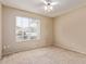 Carpeted bedroom with neutral walls, a ceiling fan, and a window with blinds at 8606 W Caribbean Ln, Peoria, AZ 85381