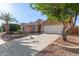 Single-story home featuring desert landscaping, shade tree and a two car garage at 8606 W Caribbean Ln, Peoria, AZ 85381
