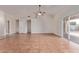 Spacious living room with tile flooring, high ceilings, and sliding doors to the backyard at 8606 W Caribbean Ln, Peoria, AZ 85381