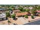 Aerial view of home in a well-maintained neighborhood with mature trees and a desert landscaped yard at 8913 W Country Club Trl, Peoria, AZ 85383