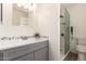 Bathroom featuring modern vanity with white countertop and glass-enclosed shower at 8913 W Country Club Trl, Peoria, AZ 85383