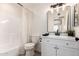 Bathroom with white vanity, updated mirror and lighting, shower and toilet at 8913 W Country Club Trl, Peoria, AZ 85383