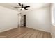 Bedroom featuring wood-look floors, a ceiling fan, and a closet at 8913 W Country Club Trl, Peoria, AZ 85383