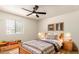 Charming bedroom with a cozy bed, rustic decor, and plenty of natural light at 8913 W Country Club Trl, Peoria, AZ 85383