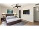 Modern bedroom with a king-size bed, neutral decor, and a wall-mounted TV at 8913 W Country Club Trl, Peoria, AZ 85383