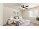 Bright bedroom with modern white furniture, light gray accents, and contemporary artwork at 8913 W Country Club Trl, Peoria, AZ 85383