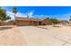 Well-maintained single-story brick home with a two-car garage, long driveway, and desert landscaping at 8913 W Country Club Trl, Peoria, AZ 85383