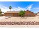 Charming single-story brick home with a two-car garage, desert landscaping, and a palm tree in the front yard at 8913 W Country Club Trl, Peoria, AZ 85383