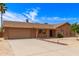 Well-maintained single-story brick home with a two-car garage, long driveway, and desert landscaping at 8913 W Country Club Trl, Peoria, AZ 85383