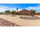 Charming single-story brick home with desert landscaping, mature trees, and a well-manicured front yard at 8913 W Country Club Trl, Peoria, AZ 85383