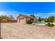 Exterior view of the detached garage and sparkling pool in the backyard at 8913 W Country Club Trl, Peoria, AZ 85383