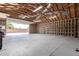 Large garage featuring open beam ceilings, block wall, and open door at 8913 W Country Club Trl, Peoria, AZ 85383