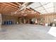 Unfinished garage with exposed rafters and various supplies at 8913 W Country Club Trl, Peoria, AZ 85383