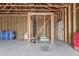 Unfinished garage featuring exposed rafters and stacked supplies at 8913 W Country Club Trl, Peoria, AZ 85383