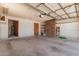 Spacious garage with an entrance to home and a brick storage section at 8913 W Country Club Trl, Peoria, AZ 85383