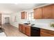 Modern kitchen with black appliances, wood cabinets, and light countertops at 8913 W Country Club Trl, Peoria, AZ 85383