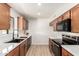 Modern kitchen with stainless steel appliances, wood cabinets, and light countertops at 8913 W Country Club Trl, Peoria, AZ 85383