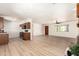 Open-concept living room with new wood floors, neutral paint, fireplace, and lots of natural light at 8913 W Country Club Trl, Peoria, AZ 85383