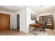 Well-lit home office featuring a modern desk, built-in shelving, and a comfortable work space at 8913 W Country Club Trl, Peoria, AZ 85383
