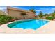 Backyard pool with blue water, concrete surround and lush green landscaping at 8913 W Country Club Trl, Peoria, AZ 85383