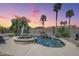 Backyard featuring a custom pool, spa, waterfall feature, and lush tropical landscaping at 9576 W Blue Sky Dr, Peoria, AZ 85383